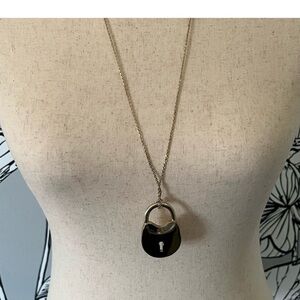 Tory Burch Surreal lock pendant.